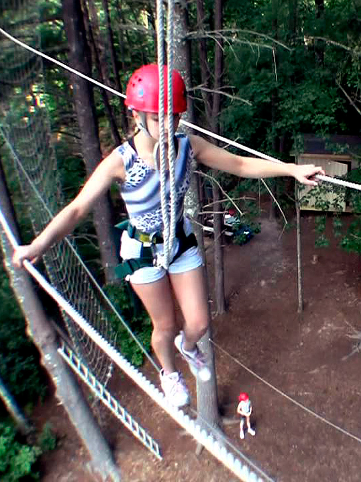 girl with helmet on ropes course